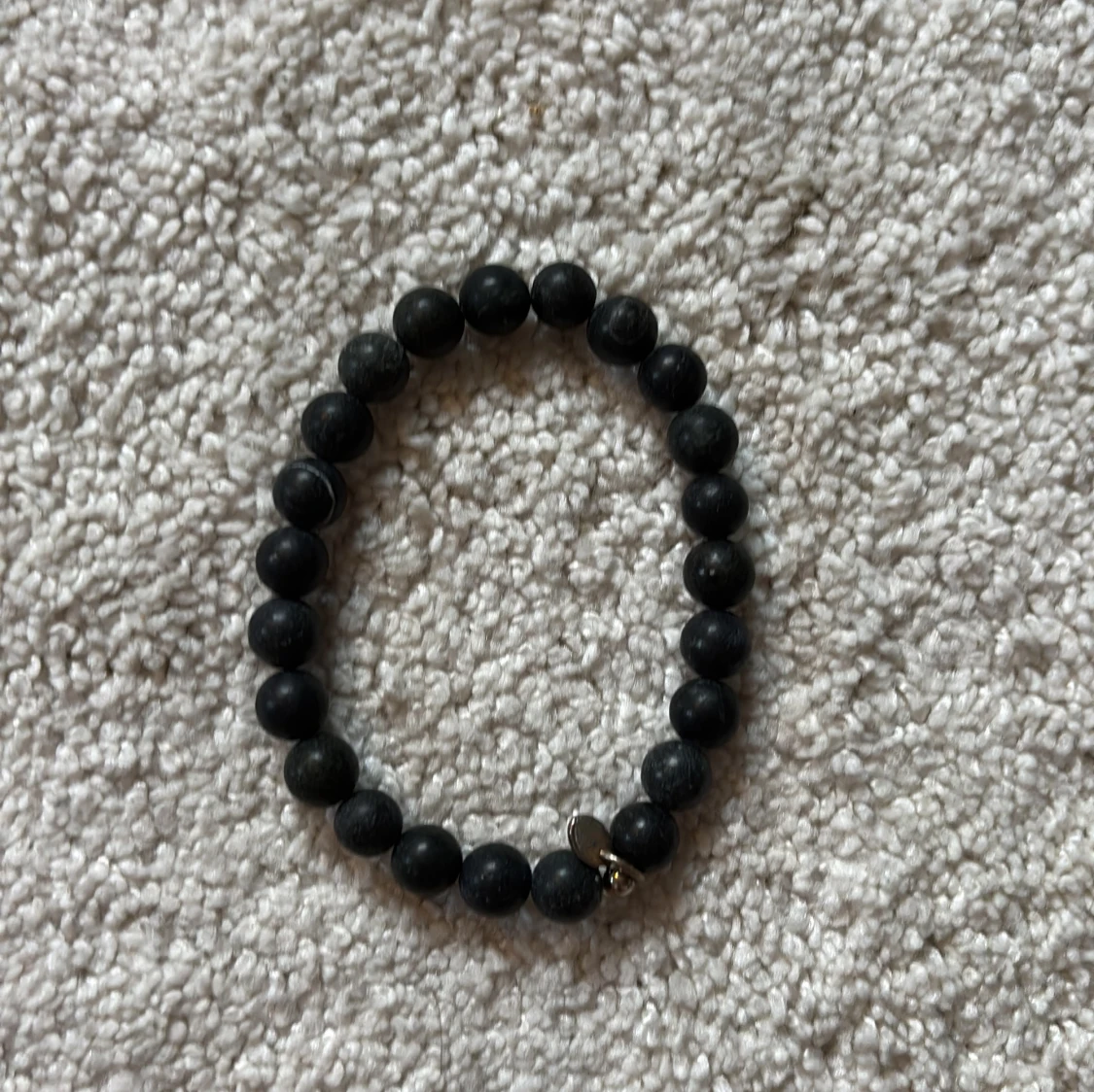 Svart pärlarmband med metallberlock