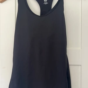 Svart sportlinne från H&M - Säljer ett svart sportlinne från H&M Sport. Linnet har en klassisk racerback-modell och är tillverkat i ett stretchigt material som passar perfekt för träning. Enkel och stilren design.