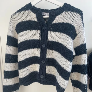 Randig stickad kofta från Zara - Säljer en stickad kofta från Zara med breda svarta och marinblåa ränder. Fint skick! Storlek S