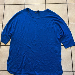 Blå tröja från Rainbow storlek 44/46 - Säljer en snygg blå tröja från Rainbow. Tröjan har en avslappnad passform med trekvartsärmar och rund halsringning. Perfekt för en casual look.