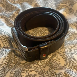 Brunt skärp med silverfärgat spänne  - Snyggt brunt skärp med ett stilrent silverfärgat spänne. Perfekt för att ge en klassisk touch till din outfit.