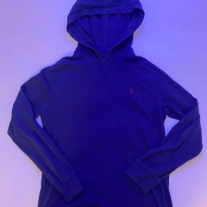 Blå Ralph Lauren tröja  - Säljer nu min blåa Ralph lauren tröja. Den har ett litet hål vid bröstet men det är jättelitet.