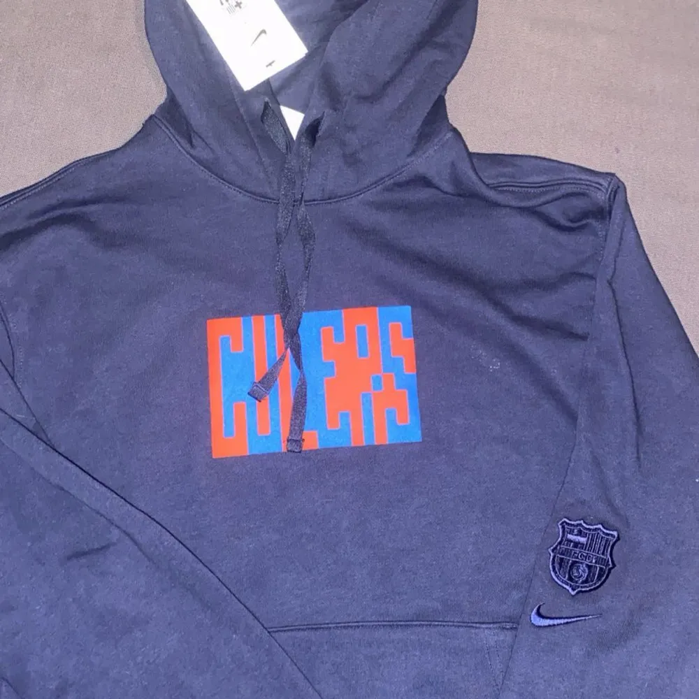 Säljer en mörkblå hoodie från Nike. Perfekt för alla Barca fotbollsfans! 🏆. Neuletakit & Villapaidat.