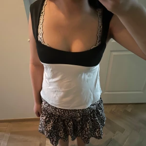 Knyt topp - Supersöt topp som är svart och vit , Svart knytband i ryggen ger en extra detalj. Perfekt för dig som vill sticka ut! Den e aldrig använd❤️