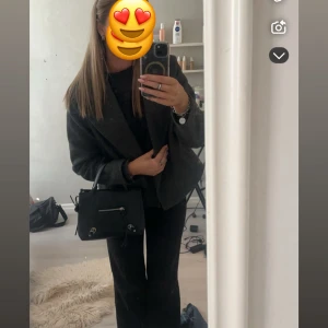 Mörkgrå kappa med bred krage - Säljer en stilren mörkgrå kappa, ganska tunn så bra till hösten