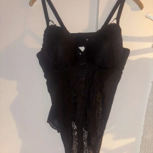Svart spetskorsett från Bodyflirt - Supersnygg svart korsett från Bodyflirt med tunna axelband och detaljer i spets framtill. Kuporna är vadderade och ger en snygg form. Perfekt att styla med jeans eller kjol!🖤🖤aldrig använt