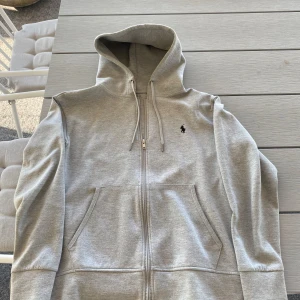 Ralph lauren zip hoodie | S - Hej! Säljer nu en ljusgrå Ralph lauren zip i bra skick, det är storlek S på tröjan! Den har en väldigt stilren look och funkar till allt! Hör av er vid funderingar! MVH VONUE🤩