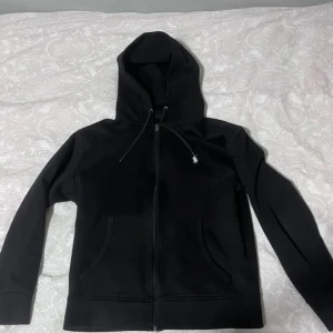 Svart polo hoodie i storke S - Säljer en svart polo hoodie med dragkedja och huva i storlek S 