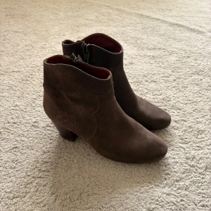 ISABEL MARANT boots - Snygga mörkbruna boots från ISABEL MARANT i mocka med låg klack och rund tå. Skorna har dragkedja på insidan och en stilren design som passar perfekt till jeans. Storlek 37 men passar större. Nypris är ca 6000kr