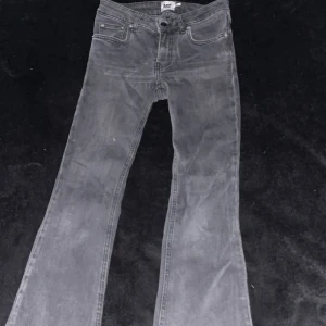 Grå bootcut jeans från 157, XS - Snygga grå jeans från 157 i bootcut-modell med låg midja. Jeansen har klassisk femficksdesign och är tillverkade i ett mjukt bomullstyg med lite stretch. Perfekta för dig som gillar en avslappnad men trendig look.