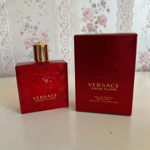 Versace Eros Flame EdP 100ml - Versace Eros Flame Eau de Parfum i en snygg röd glasflaska med guldigt lock och ikoniskt Medusa-huvud. Flaskan rymmer 100 ml och kommer med matchande röd kartong. En lyxig och intensiv doft som sticker ut både i design och känsla.