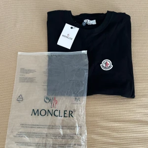 Svart t-shirt från Moncler - Säljer en helt ny svart t-shirt från Moncler med klassisk Moncler-logga på bröstet. 