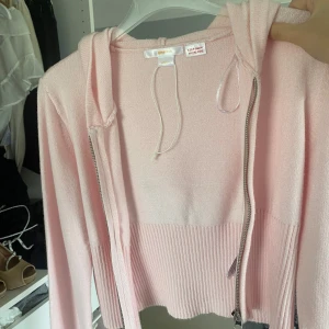 Ljusrosa kofta från Gina tricot  - Supersöt ljusrosa kofta från Gina Tricot med dragkedja och snörning i huvan. Tröjan är croppad med ribbad nederkant och långa ärmar. Skriv privat för fler bilder🥰