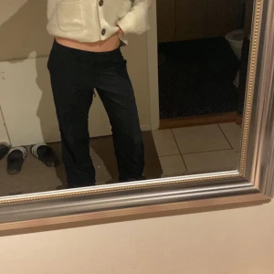 Svarta linne byxor  - Säljer ett par svarta linne  byxor med normal passform och rak siluett. Byxorna har en enkel design utan synliga detaljer och passar perfekt till en avslappnad stil. Midjan är låg och materialet känns mjukt och bekvämt.