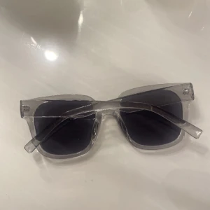 snygga solglasögon  - Snygga solglasögon från glitter!! Bågarna har en klassisk form som passar de flesta ansikten. Perfekt accessoar för att lyfta din stil. Skulle säga att dom är ljusgråa som e riktigt snygg färg på glajjor 