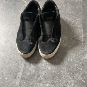 Svarta mocka skor från Axel Arigato - Svarta mocka skor från Axel Arigato. Små hål i botten av skon som man knappt lägger märke till och annars i väldigt bra skick. Storlek 40 men passar 39-41,5