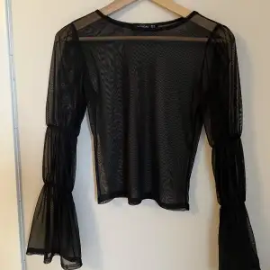 Nasty Gal black mesh top with the most fun sleeves 🖤  Perfect for layering under dresses/tops!   Size UK 8 🖤