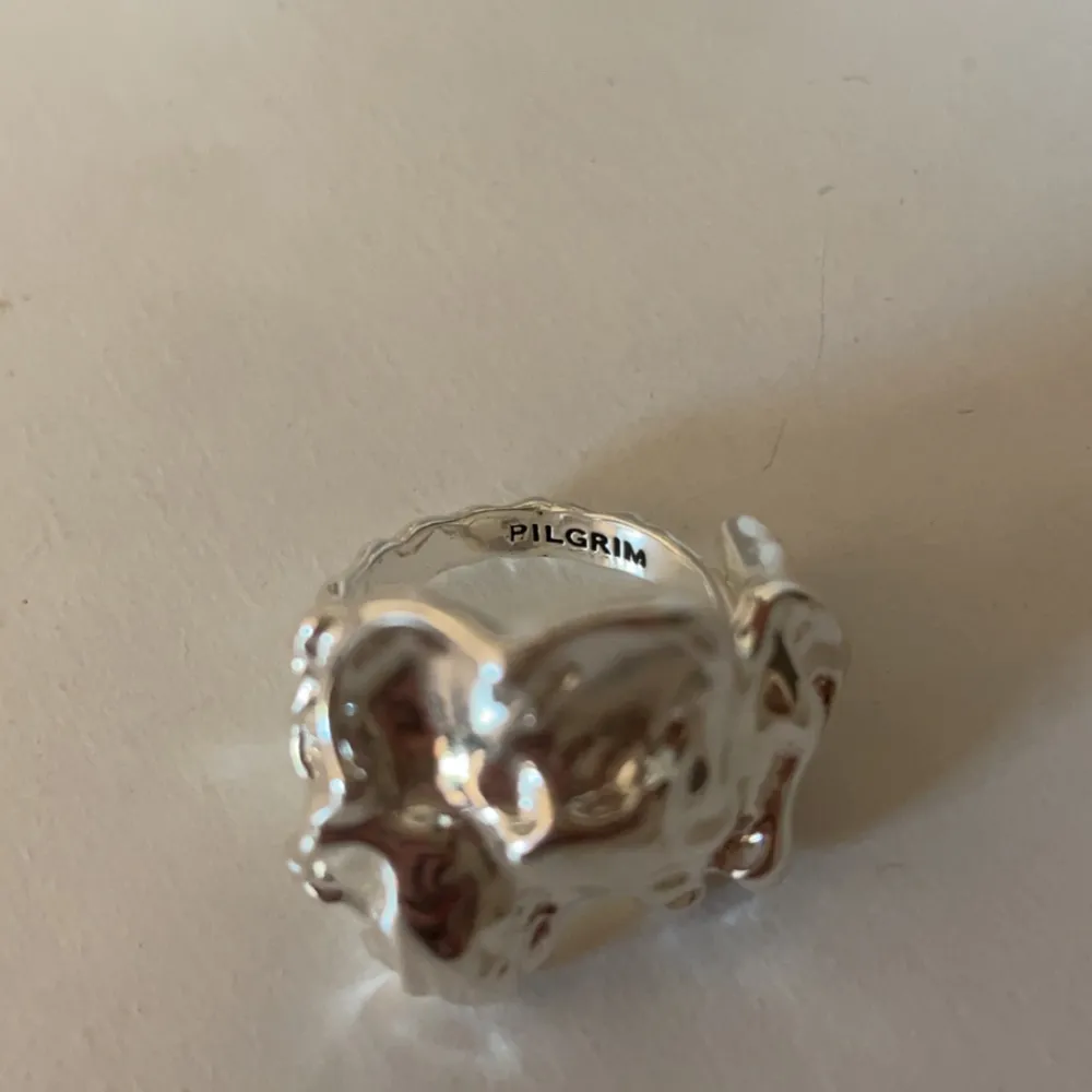Silver ring från pilgrim, den är justerbar och i väldigt fint skick kanske använd en eller två gåner. Accessoarer.