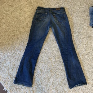 Lågmidjade levis bootcut 572 jeans - Jättefina jeans från Levis. Innerbenslängd:77cm Midja:36*2cm Dom är i bra skick säljer för jag har för mycket byxor.  Hel längd:100cm