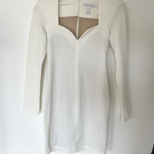 Vit klänning - Vit figursydd klänning med axelvaddar. Även insydd underkjol så man inte ser igenom. Sååå fin klänning men jag har tyvärr växt ur den. Axelvaddarna gör det lilla extra så den ser lite extra lyxig ut.