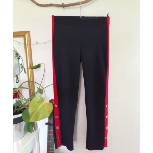 Tygbyxor  - Tygbyxor från Ginatricot i mycket bra skick. Byxorna har röd rand och knappar nertill på båda sidorna. Storlek M. 🌼 