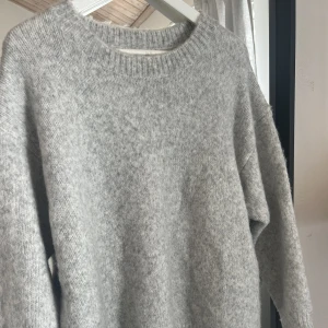 Stickad tröja Zara  - Ljusgrå, stickad tröja från Zara. Tröjan är i nyskick och i storlek M - skulle däremot säga att det är en S 