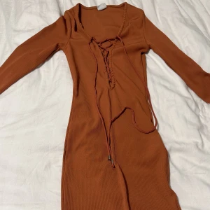 Klänning - Den är jättebekväm och detaljerna vid snörerna är i silvermetall.