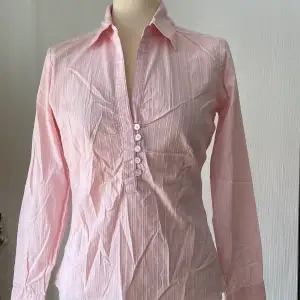 Mjuk rosa skjorta mycket smikrande mig brösten då den är draperad. Figursydd.  Mycket fint skick