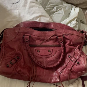 Balenciaga väska - Vintage Balenciaga city bag köpt för 8500kr, äkthetsbevis finns!💕Säljer då jag ej använder längre, finns vissa skador, en ”plupp” har åkt av, skriv för bild! Den är i bra skick men som sagt är den vintage! Kan diskutera pris🫶🏼Färg:rosa/vinröd