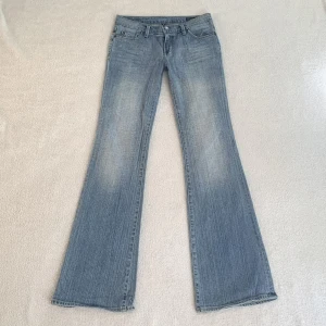 Lågmidjade jeans - Lågmidjade utsvängda vintage jeans, från märket Sacred Blue Jeans! Jag är 173 cm, midjemåttet är 76 cm och innerbenslängden 82 cm 💕