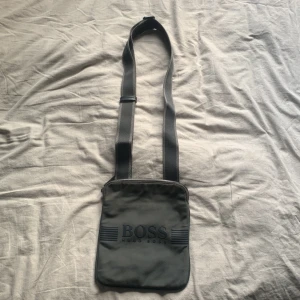 Hugo boss väska -  Säljer den för att jag har tröttnat på den haft ungefär ett halv år på andra bilden ser ni att dragkedjan har lossnat