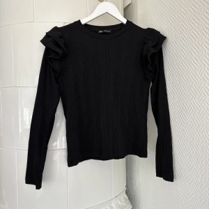 Topp - Svart topp från Zara med volanger på axlarna. Jättefin, köpt förra året och aldrig använd - som ny! 🖤