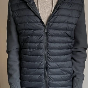 Save The Duck cardigan - Säljer nu min jätte snygga save the duck cardigan/jacka. Storleken är M men passar också jätte bra på dig som har S. Färgen på dunet är svart och tyget är lite ljusare svart. Hör av er vid fler frågor eller funderingar 🙂