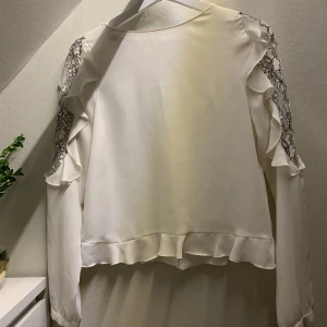 Vit blus - Fin blus från Zara med spetsdetaljer på ärmarna och knäppning i ryggen. 