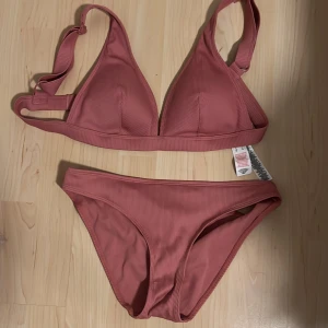 Pink bikini  - Completely new, not worn, tags still on to and bottom piece. Comfortable padded top piece. Top peice is adjustable.    Further description on size : top- 14uk/42 eu, bottom- 10uk/38eu