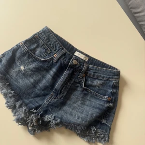 Mörkblå jeansshorts från One Teaspoon - Säljer ett par mörkblå jeansshorts från One Teaspoon. Köpta här på Plick men tyvärr fel storlek för mig. Shortsen är i stl 34 men lite små i storlek.
