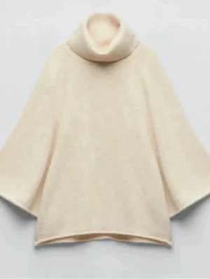 Beige stickad poncho med polokrage - Säljer en beige stickad poncho med breda ärmar och hög polokrage. Ponchon har en lös och avslappnad passform, perfekt att slänga över en tröja. Materialet ser mjukt och mysigt ut, och färgen är neutral vilket gör den lätt att matcha.