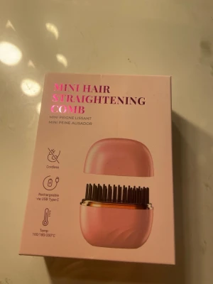 Mini rosa hårutredande värmekam - Söt och kompakt mini hårutredande värmekam i rosa med svarta piggar och detaljer i roséguld. Sladdlös och uppladdningsbar via USB-C. Perfekt för att snabbt styla håret med temperaturval mellan 160/180/200°C. Smidig att ta med i väskan.