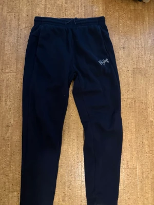 Mörk blåa mjukisbyxor från Race Marine - Säljer ett par svarta mjukisbyxor från Race Marine med broderad RM-logga på benet. Byxorna har resår i midjan och är gjorda i mjukt, fleecefodrat material som är perfekt för chill dagar. Klassisk passform och sköna fickor på sidorna. Billigare vid snabba köp