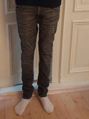 Nudie Jeans Lean Dean Hurricane  - Säljer ett par grå slim fit jeans från Nudie Jeans Lean Dean Hurricane i strl. W 27 L32. Jeansen är i absolut nyskick. Säljs enbart för att jeansen har blivit för små. Nypris 1599:-