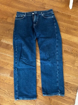 Blå raka jeans från district fortysix - Säljer ett par klassiska blå jeans från district fortysix i rak modell. Jeansen har fem fickor, normal midja och är tillverkade i ett robust denimtyg. 