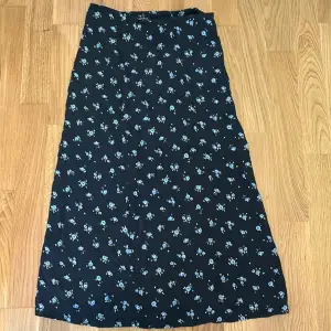 En mörkblå blommig brandy Melville kjol som slutar strax under knäna.Står inte storlek men passar en 34.Perfekt till skolavslutningen!