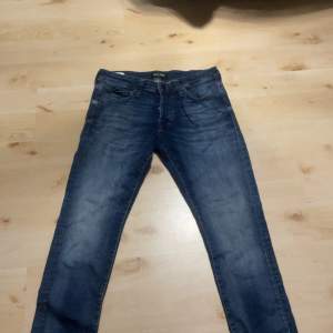 Det är ett par blåa Jack & Jones jeans som är i modellen slim/glenn i mycket bra skick