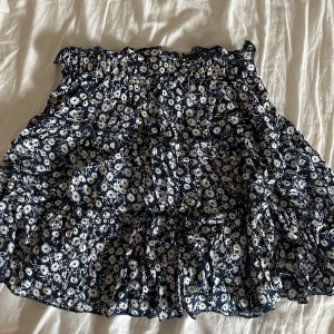 Minikjol - Denna supergulliga minikjol, blå med blommor. Strl XS/S. Perfekt till sommaren/våren. Säljer för endast 80 kr.💗