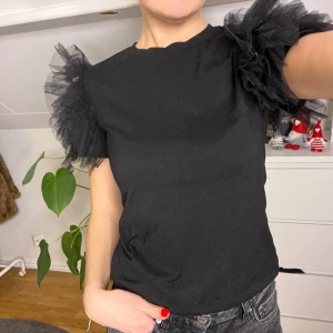 Topp - Svart topp med volanger på ärmarna, så fin. Säljer pga inte använder den 🥰