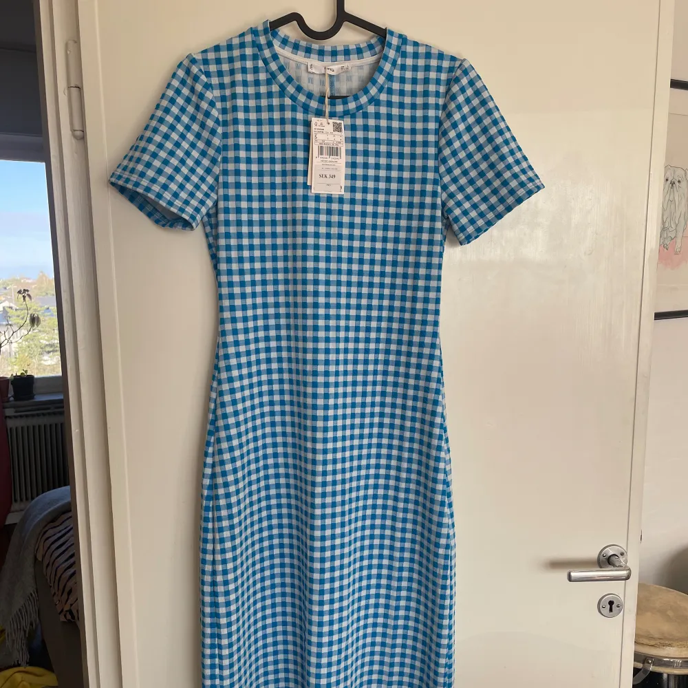 Första bilden lånad (för uppfattning av passform)! Gingham midiklänning från MANGO. Oanvänd. Köpte för två somrar sedan men inte kommit till användning tyvärr. Finns en liten slits längst ner på baksidan.. Mekot.
