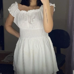 Sommar klänning  - En vit sommar klänning som är off shoulder men man kan ha den över axlarna också. Den är endast använd ett par gånger. Den är i storlek M men passar mig som har S.