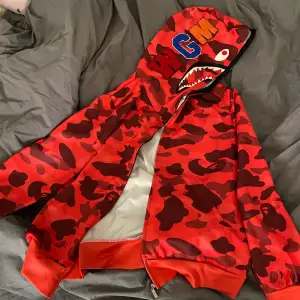 En röd hoodie köpt på amazon, helt ny aldrig använt, storlek M, typ tränings material, kan mötas upp i Uppsala eller skicka på post men då står köparen för frakt 