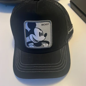 En mickey mousse keps  - En svart keps som är i sådär skick använd ett par gånger 