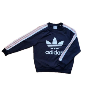 Adidas sweatshirt  - Adidas sweatshirt i storlek M, men passar S. Tre rosa sträck längs ärmarna, mycket bra skick. 150kr exklusive frakt. Kan mötas upp i Stockholm. 